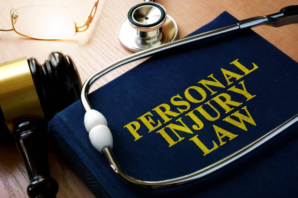 Navy law book with personal injury law in gold capital letters with stethoscope and gavel