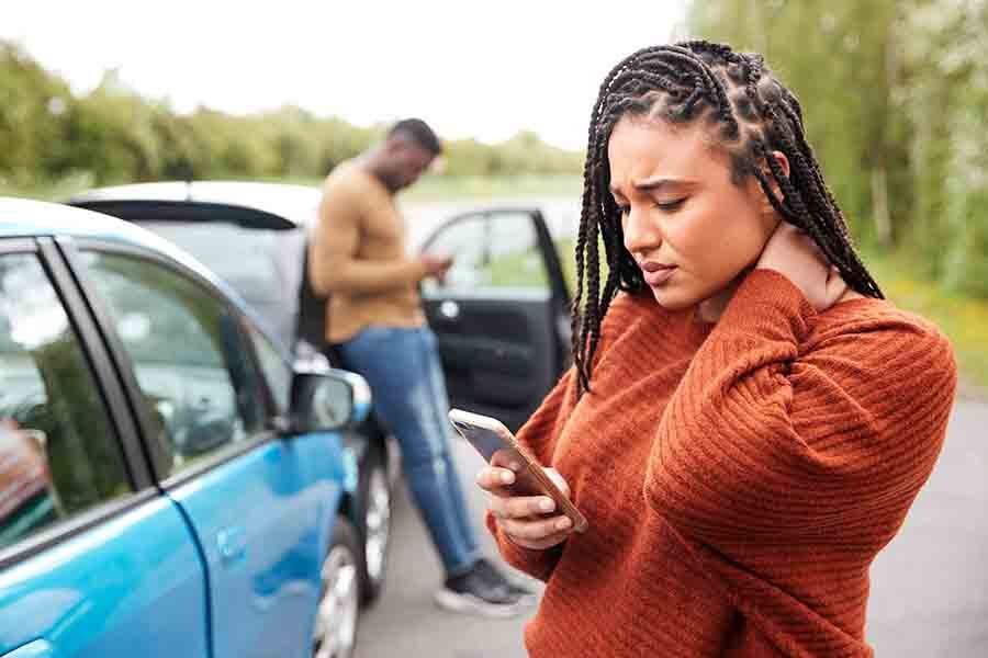 A woman holding her neck after a car accident